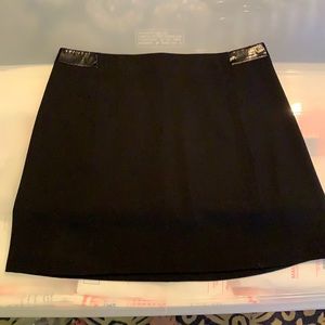 Eli Tahari lined black mini skirt with black patent leather trim.